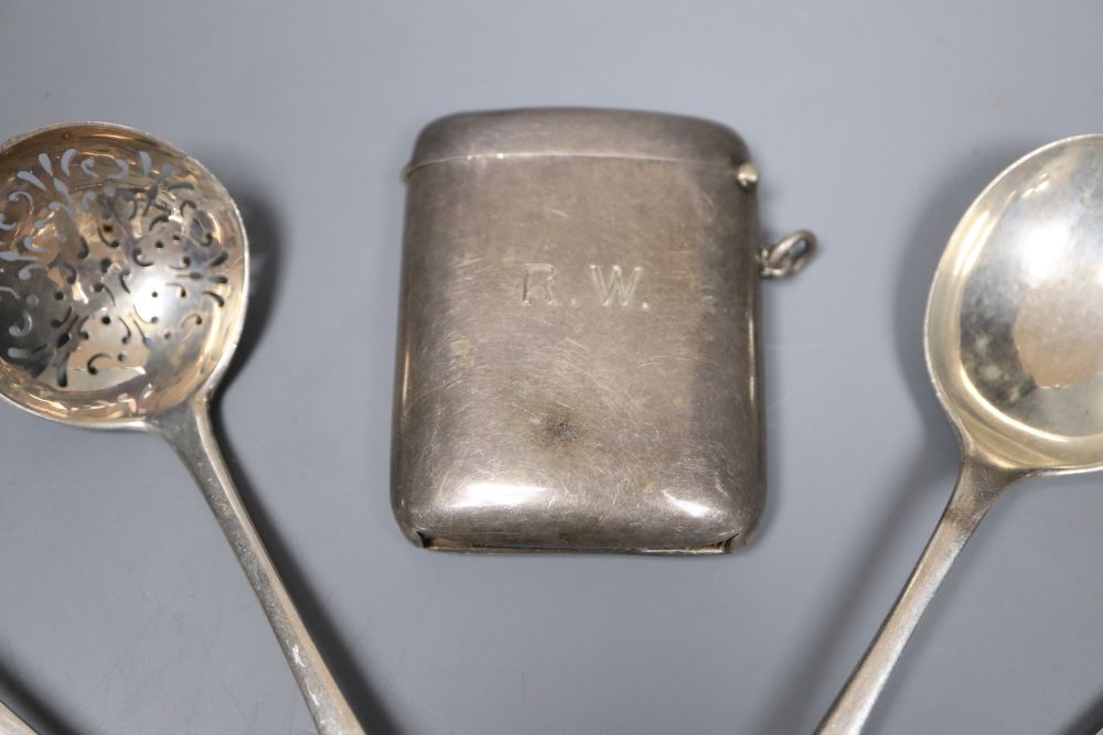 A George V silver vesta case and thirteen pieces of cutlery including eight silver.